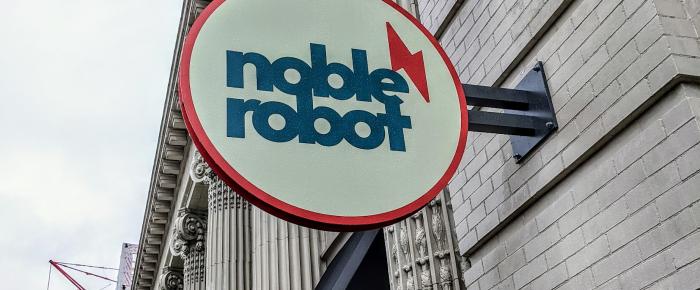 A photo of the sign above the door outside the Noble Robot office in Minneapolis.