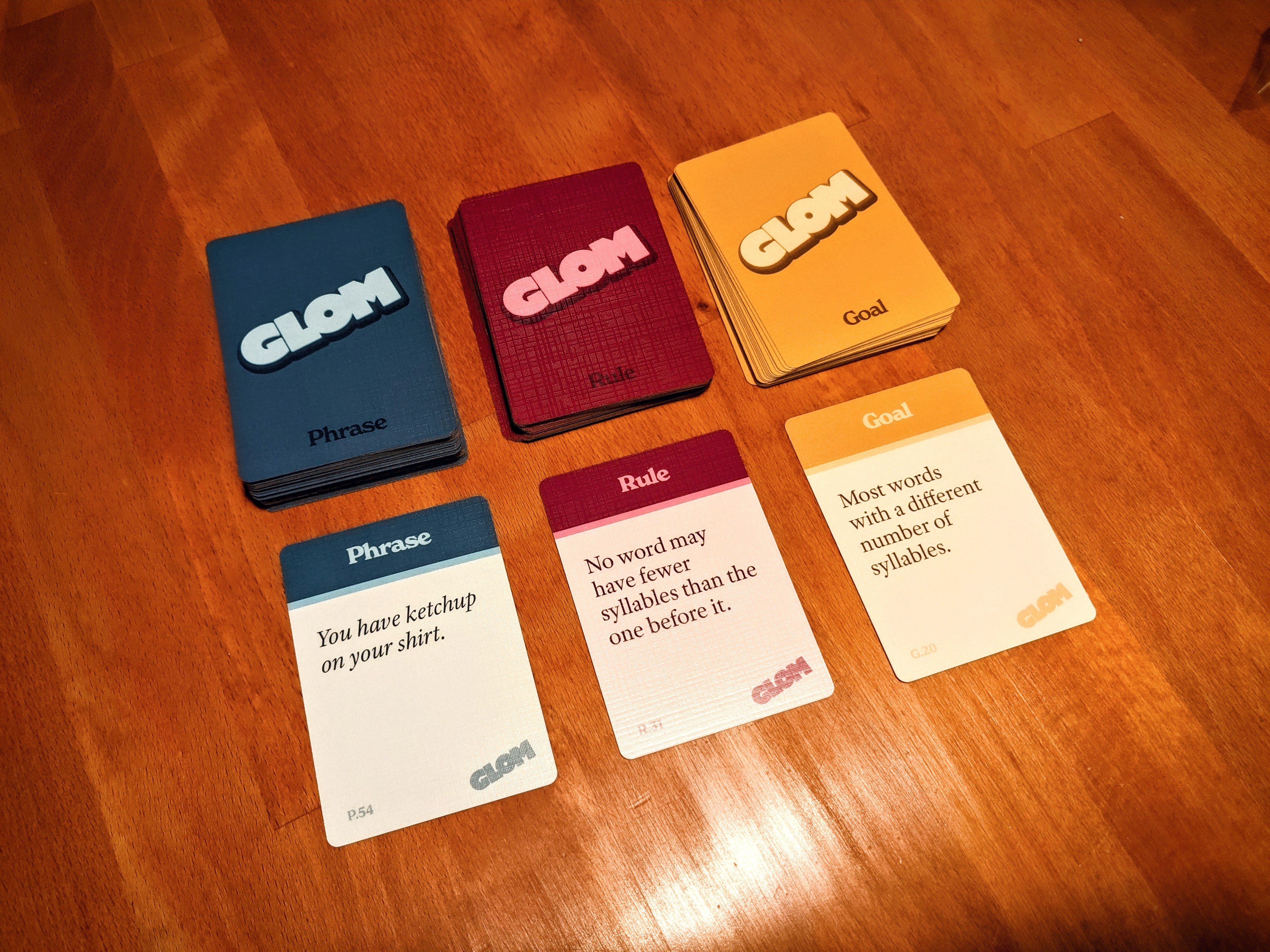 A photo showing the three card decks that make up Glom.